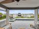 Relaxing covered patio with comfortable seating and beautiful views of the pool and waterfront at 464 20Th Ave, Indian Rocks Beach, FL 33785