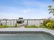 View of the canal from the pool, with a dock and a boat at 464 20Th Ave, Indian Rocks Beach, FL 33785
