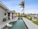 Gorgeous outdoor pool and patio with beautiful waterfront views and lush tropical landscaping at 464 20Th Ave, Indian Rocks Beach, FL 33785