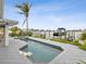 Backyard with a swimming pool, hot tub, tropical plants, and a view of the canal at 464 20Th Ave, Indian Rocks Beach, FL 33785