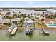 Waterfront home featuring a private dock, lush landscaping, and stunning views of the canal and surrounding area at 464 20Th Ave, Indian Rocks Beach, FL 33785
