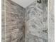 Close-up of a shower with herringbone pattern tile, a modern shower head, and sleek fixtures at 464 20Th Ave, Indian Rocks Beach, FL 33785