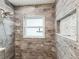 Stylish shower featuring wood-look tiles, a niche, and a rain shower head at 464 20Th Ave, Indian Rocks Beach, FL 33785