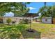 Spacious backyard with lush lawn, patio area, and storage shed at 4701 W Wyoming Ave, Tampa, FL 33616