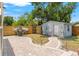 The backyard features a brick patio, a storage shed, a privacy fence, and a nicely landscaped walkway at 4701 W Wyoming Ave, Tampa, FL 33616