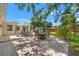 Spacious backyard featuring two patio areas, a lawn, and mature trees at 4701 W Wyoming Ave, Tampa, FL 33616
