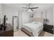 Cozy bedroom featuring neutral tones, a ceiling fan, and a comfortable bed at 4701 W Wyoming Ave, Tampa, FL 33616