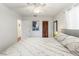 Bedroom with a grey bed, white ceiling fan, and warm lighting at 4701 W Wyoming Ave, Tampa, FL 33616