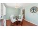 Cozy dining area featuring a round glass table, four chairs, and an adjacent view of the kitchen at 4701 W Wyoming Ave, Tampa, FL 33616
