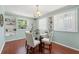 Inviting dining area featuring a round glass table, white chairs, and built-in shelves near a bright window at 4701 W Wyoming Ave, Tampa, FL 33616