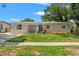 Charming single-story home features a well-manicured lawn, blue door, and inviting curb appeal at 4701 W Wyoming Ave, Tampa, FL 33616