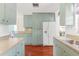 Spacious kitchen with abundant storage, a modern refrigerator, and hardwood floors at 4701 W Wyoming Ave, Tampa, FL 33616