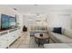 Inviting living room featuring a large sectional, stylish round table, and entertainment center with a TV at 4701 W Wyoming Ave, Tampa, FL 33616