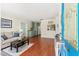 Inviting living room features wood floors, comfortable seating, and an open layout into the kitchen at 4701 W Wyoming Ave, Tampa, FL 33616
