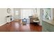 Open-concept living room with wood floors, large windows, and a view to the adjacent kitchen at 4701 W Wyoming Ave, Tampa, FL 33616