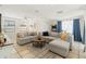 Spacious living room with a comfortable sectional sofa, area rug, and bright natural lighting at 4701 W Wyoming Ave, Tampa, FL 33616