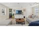 Comfortable living room with a sectional couch, entertainment center with a TV, and a view to the kitchen at 4701 W Wyoming Ave, Tampa, FL 33616