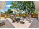 Outdoor patio area with a dining table, grill, umbrella, and fenced yard at 4701 W Wyoming Ave, Tampa, FL 33616
