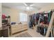 Bright walk-in closet includes installed shelving, dresser, and window at 4701 W Wyoming Ave, Tampa, FL 33616