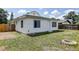 Charming backyard with grassy area and a quaint fire pit perfect for outdoor relaxation at 508 N Walker St, Plant City, FL 33563