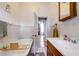 Vintage bathroom featuring decorative tile, bathtub and a vanity with a sink at 508 N Walker St, Plant City, FL 33563