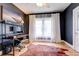 Office/bedroom with dark grey walls, a work station and light wood floors at 508 N Walker St, Plant City, FL 33563