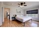 Bedroom features laminate floors, ceiling fan, large window, and neutral decor at 508 N Walker St, Plant City, FL 33563
