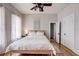Bright and airy bedroom with hardwood floors, ceiling fan, and neutral decor at 508 N Walker St, Plant City, FL 33563