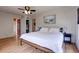 Bedroom features laminate floors, ceiling fan, large window, and neutral decor at 508 N Walker St, Plant City, FL 33563