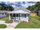 A sunny aerial view of a charming single-story home with a metal roof and well-maintained landscaping at 508 N Walker St, Plant City, FL 33563