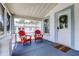 Inviting screened-in front porch with cozy seating and view of landscaped yard at 508 N Walker St, Plant City, FL 33563