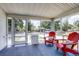 Comfortable screened porch featuring painted wood floors and casual seating at 508 N Walker St, Plant City, FL 33563