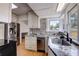 Bright kitchen features stainless appliances, stone counters, mosaic backsplash and a view to the backyard at 508 N Walker St, Plant City, FL 33563