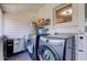 Well lit laundry room with white paneling and side-by-side washer and dryer at 508 N Walker St, Plant City, FL 33563