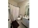 Simple bathroom featuring a toilet, sink and shower curtain at 527 Glenn Cross Dr, Ruskin, FL 33570