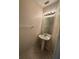 Elegant half bathroom with a pedestal sink and modern lighting fixtures at 527 Glenn Cross Dr, Ruskin, FL 33570