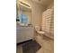 This bathroom features a modern vanity, a neutral color palette, and a shower-tub combination at 527 Glenn Cross Dr, Ruskin, FL 33570