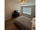 This bedroom offers ample natural light, complemented by warm wood-look floors and a modern ceiling fan at 527 Glenn Cross Dr, Ruskin, FL 33570