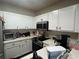 Bright kitchen featuring white cabinets, stainless steel appliances, and quartz countertops at 527 Glenn Cross Dr, Ruskin, FL 33570