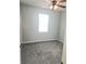 A bright bedroom with a ceiling fan, neutral walls, plush gray carpeting, and lots of natural light at 5303 Terraza Ct, Temple Terrace, FL 33617