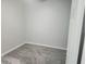 A cozy bedroom featuring plush gray carpeting, neutral walls, and bright natural light at 5303 Terraza Ct, Temple Terrace, FL 33617