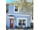 Charming townhouse featuring a red door and light blue exterior paint at 5303 Terraza Ct, Temple Terrace, FL 33617