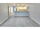 Open-concept living room and kitchen with new gray carpeting at 5303 Terraza Ct, Temple Terrace, FL 33617