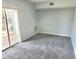 Large living room features new gray carpeting and sliding door to the outside at 5303 Terraza Ct, Temple Terrace, FL 33617