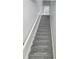 Staircase with new carpeting leads to the upper level at 5303 Terraza Ct, Temple Terrace, FL 33617