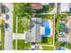 An aerial view of the house showcases a pool and lush greenery and well-maintained yard, highlighted by the roof at 5925 18Th Ne St, St Petersburg, FL 33703