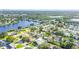 Aerial view of the home with a pool, landscaping, and nearby lake at 5925 18Th Ne St, St Petersburg, FL 33703
