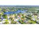 An aerial view of a home with a pool, surrounded by trees and residential properties in a neighborhood at 5925 18Th Ne St, St Petersburg, FL 33703