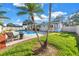 Serene backyard featuring a refreshing pool, brick-paved area, and mature palm trees for a tranquil oasis at 5925 18Th Ne St, St Petersburg, FL 33703