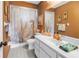 Bathroom with a tub and shower with a single sink vanity and decorative accents at 5925 18Th Ne St, St Petersburg, FL 33703